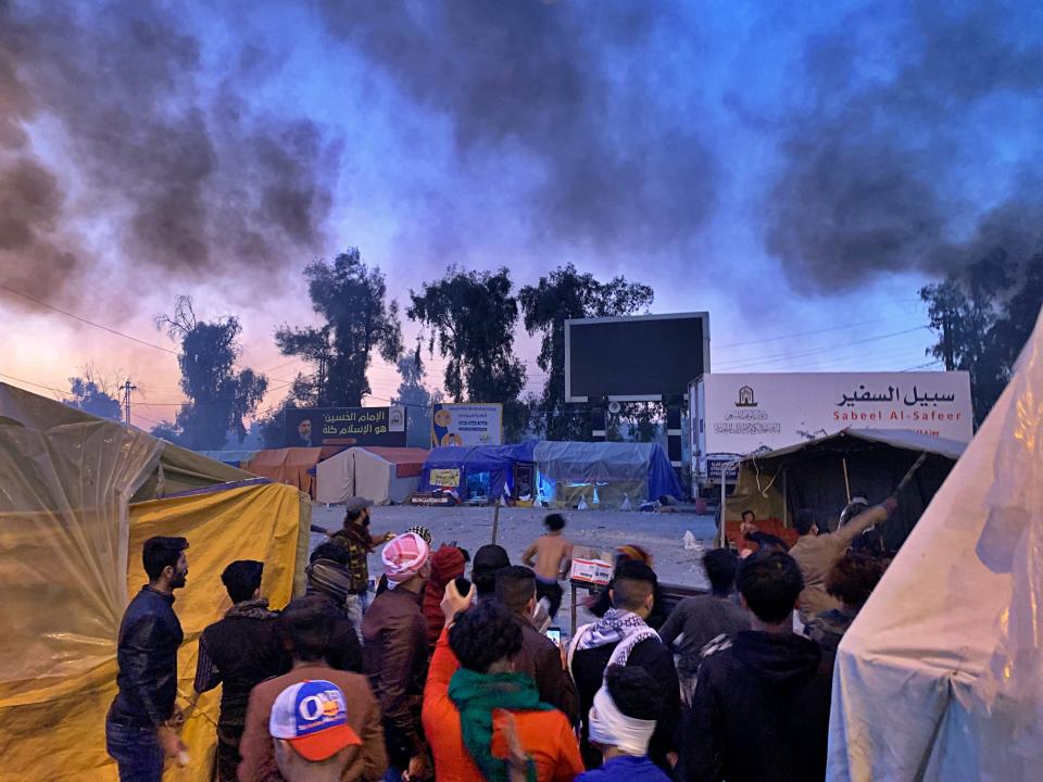 Smoke rises from the sites of anti-government protests in Najaf, Iraq, Wednesday, Feb. 5, 2020. Iraqi officials and activists say multiple anti-government protesters have been shot dead and dozens wounded in clashes with followers of radical Shiite cleric Muqtada al-Sadr in the holy city of Najaf in southern Iraq. (AP Photo/Anmar Khalil)