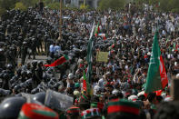 Supporters of Pakistan’s defiant former Prime Minister Imran Khan chant slogans next to paramilitary soldiers stopping them to march towards parliament during an anti-government rally in Islamabad, Pakistan, Thursday, May 26, 2022. Khan early Thursday warned Pakistan's government to set new elections in the next six days or he will again march on the capital along with 3 million people. (AP Photo/Anjum Naveed)