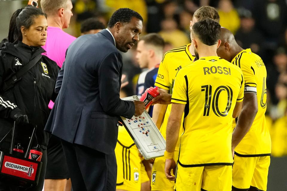 Crew coach Wilfried Nancy talks to forward Diego Rossi during Saturday's loss to FC Cincinnati.