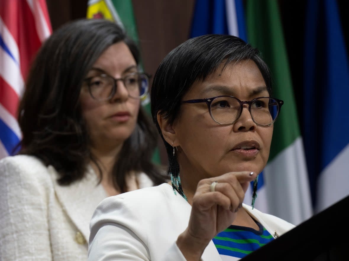 NDP MP for Nunavut Lori Idlout speaks during a news conference in Ottawa Thursday while NDP MP for Churchill-Keewatinook Aski Niki Ashton looks on.   (Adrian Wyld/The Canadian Press - image credit)