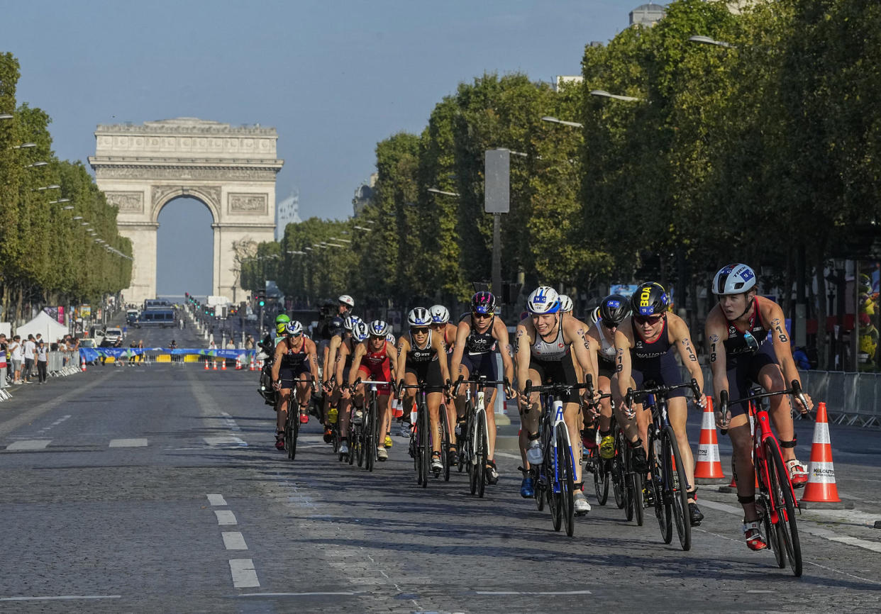 The first leg of the women's triathlon test event for the 2024 Olympics Games, on the Avenue des Champs-Élysées on Aug. 17, 2023.  (Michel Euler / AP)