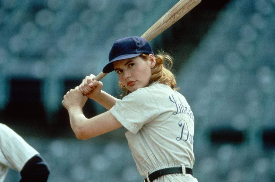 Geena Davis holding a baseball bat.