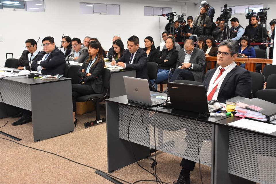 In this photo provided by Peru's Supreme Court communications office, former Peruvian first daughter Keiko Fujimori, top center with her arms folded, sits in court where Judge Richard Concepcion ruled that she should be detained as a preventative measure while prosecutors investigate allegations she led a criminal network within her party that received about $1 million in payments from Brazilian construction giant Odebrecht, in Lima, Peru, Wednesday, Oct. 31, 2018. Keiko Fujimori denies she accepted money from Odebrecht during her 2011 presidential run and has called the investigation a political witch hunt. (Peru's Supreme Court communication office via AP)