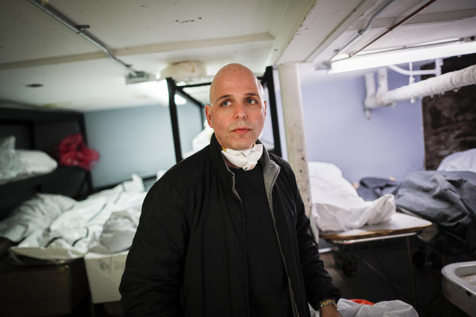 Pat Marmo, owner of Daniel J. Schaefer Funeral Home, walks through his body holding facility that is struggling to handle overflow of clients stemming from COVID-19 deaths, Thursday, April 2, 2020, in the Brooklyn borough of New York. "This is a state of emergency," he said. "We need help." (AP Photo/John Minchillo)