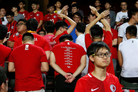 Football Soccer - Hong Kong v Malaysia - AFC Asian Cup Qualifiers - Hong Kong, China – October 10, 2017 - Hong Kong fans turn their backs during Chinese national anthem. REUTERS/Bobby Yip