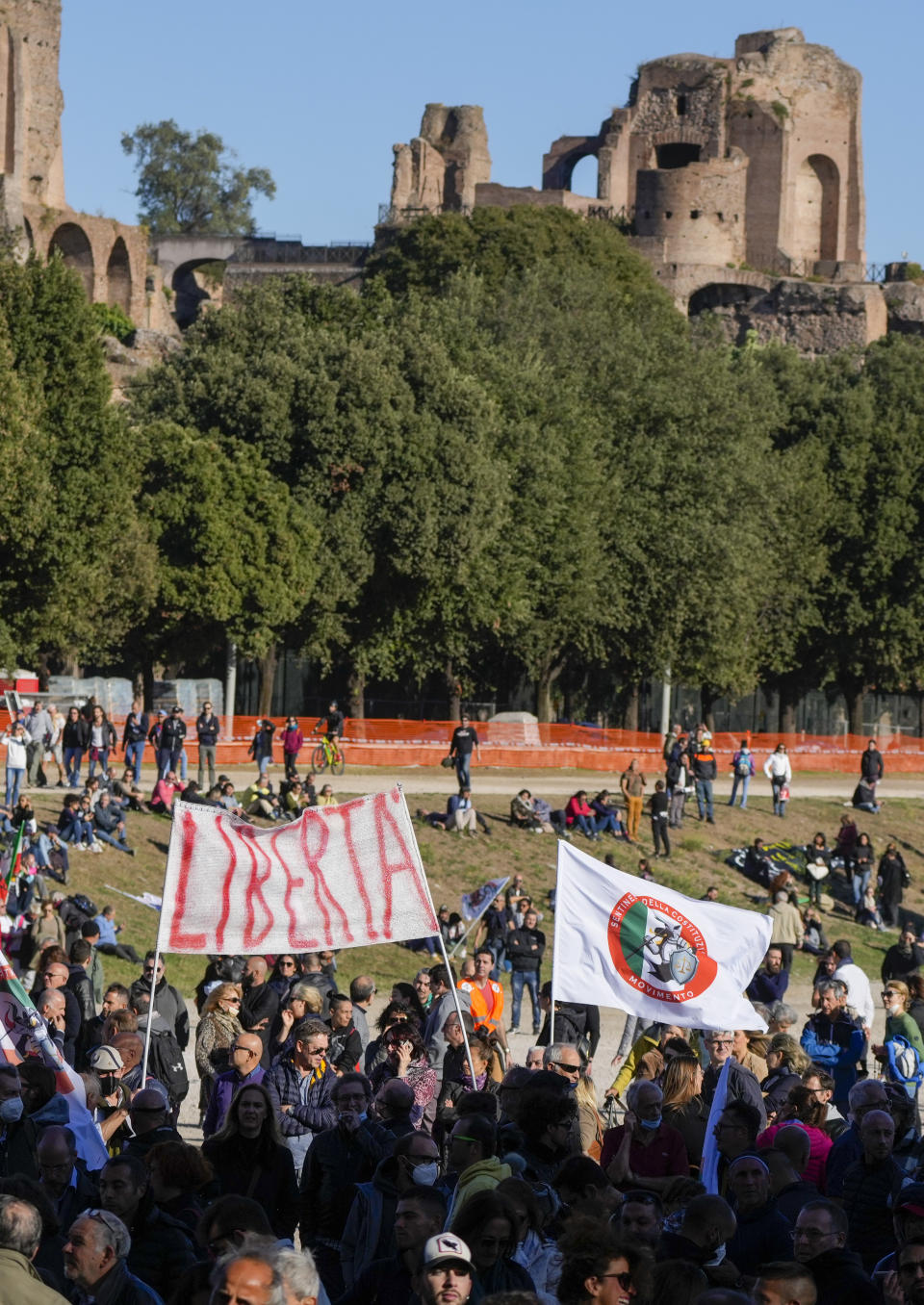 Demonstrators gather at Rome's Circus Maximus, Friday, Oct. 15, 2021, to protest a new anti COVID-19 measure requiring all workers to show a health pass to enter their place of employment. Banner in Italian reads: "Liberta'" (Freedom). (AP Photo/Gregorio Borgia)