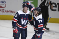 Washington Capitals right wing Anthony Mantha (39) celebrates his goal with right wing T.J. Oshie (77) during the second period of an NHL hockey game against the Buffalo Sabres, Thursday, April 15, 2021, in Washington. (AP Photo/Nick Wass)