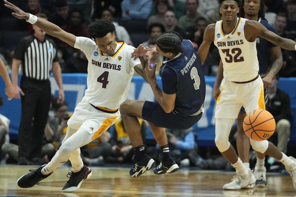 Arizona State's Desmond Cambridge Jr. (4) and Nevada's Trey Pettigrew (3) go for a loose ball during the first half of a First Four college basketball game in the NCAA men's basketball tournament, Wednesday, March 15, 2023, in Dayton, Ohio. (AP Photo/Darron Cummings)