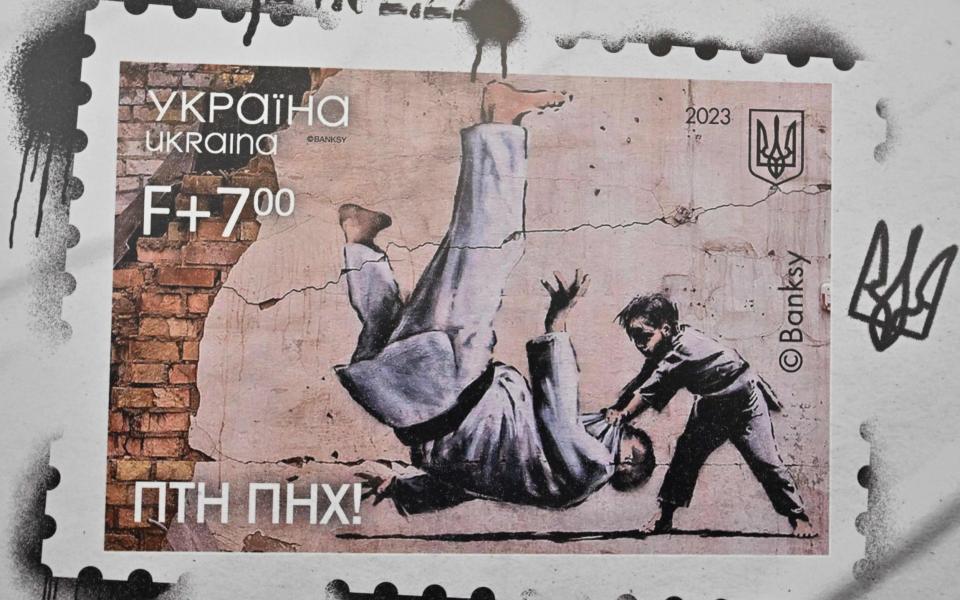 The stamp reproduces a Banksy mural made on the wall of a destroyed building in Borodyanka - Sergei SUPINSKY / AFP