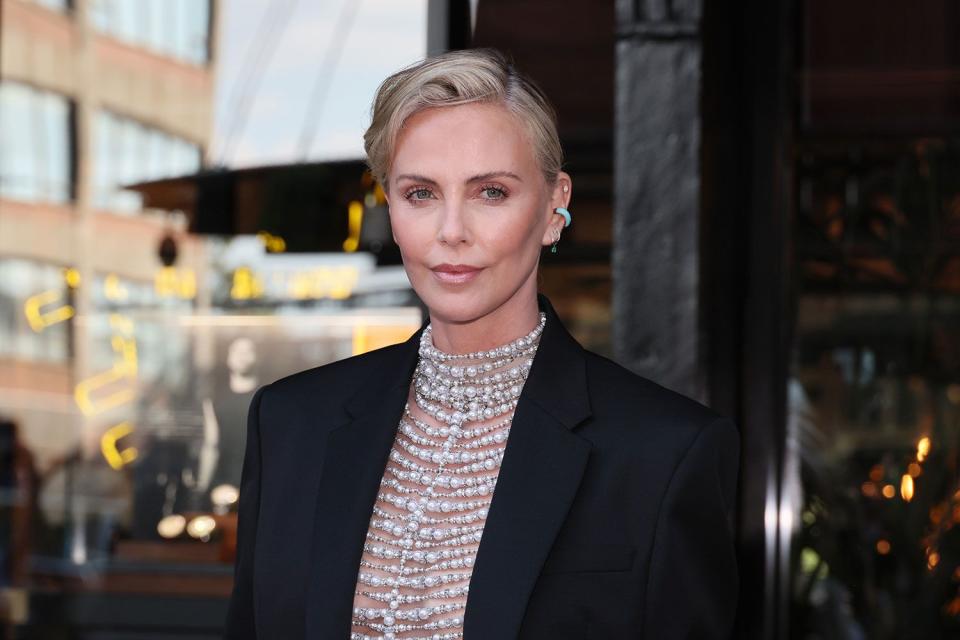 <p>Dia Dipasupil/Getty</p> Charlize Theron rocks a pearl bodice top as she attends the grand opening of Breitling