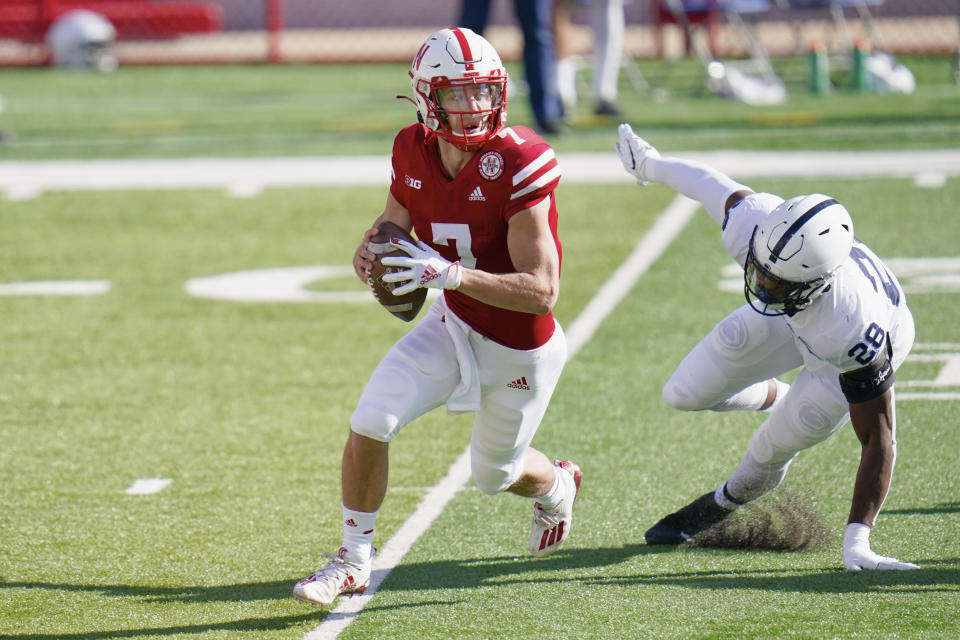 Nebraska quarterback Luke McCaffrey (7) is pursued by Penn State defensive end Jayson Oweh (28) during the first half of an NCAA college football game in Lincoln, Neb., Saturday, Nov. 14, 2020. (AP Photo/Nati Harnik)