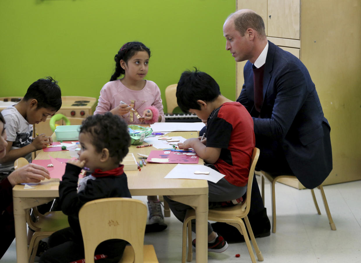 Britain's Prince William engages with children in the Young Mothers program during his visit to Roca on Thursday, Dec. 1, 2022, in Chelsea, Ma. (Nancy Lane/The Boston Herald via AP, Pool)
