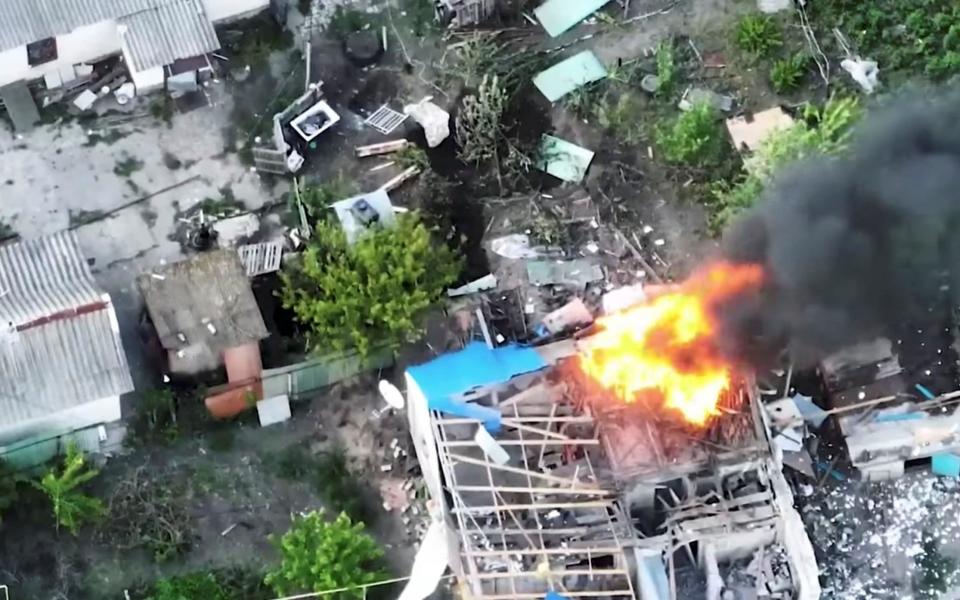 Smoke rises after an explosion of a building, which according to the Ukrainian military shows a Russian army position set up near a private house being attacked