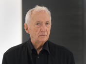 FILE - French painter Pierre Soulages poses next to one of his works at the Pompidou Center in Paris, Tuesday Oct. 13, 2009. French painter Pierre Soulages, who was famed for his use of black and was an icon of post-World War II European abstract art, has died, according to the Soulages Museum in his hometown. He was 102. (AP Photo/Remy de la Mauviniere, File)