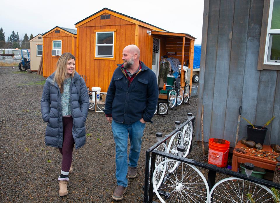 EveryOne Village site lead Gina Piechowicz, left, and her husband, Pastor Gabe Piechowicz, walk past a group of homes called Cottages of Hope that are being built in cooperation with Lane Workforce Partnership, Lane ESD and area schools.