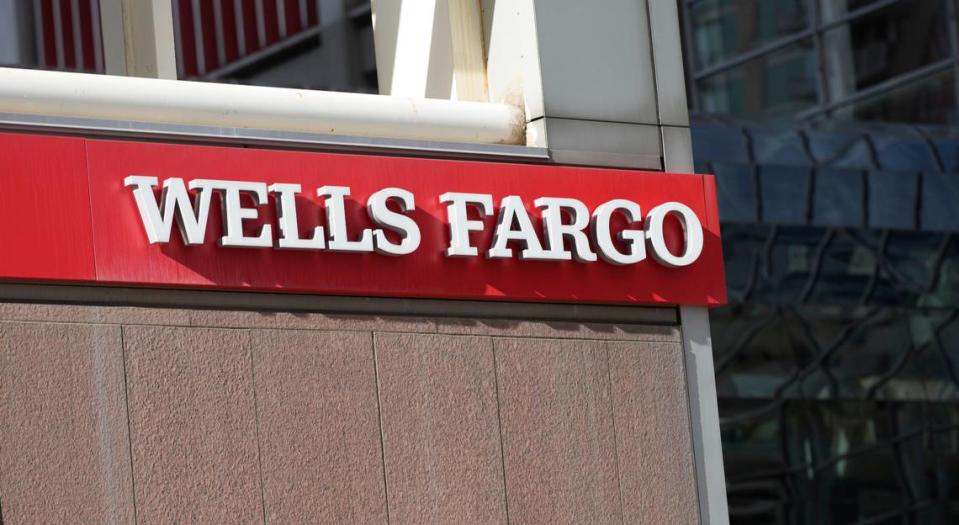 Sunshine illuminates the company logo over the entrance to a Wells Fargo bank location in downtown Denver. (AP Photo/David Zalubowski)