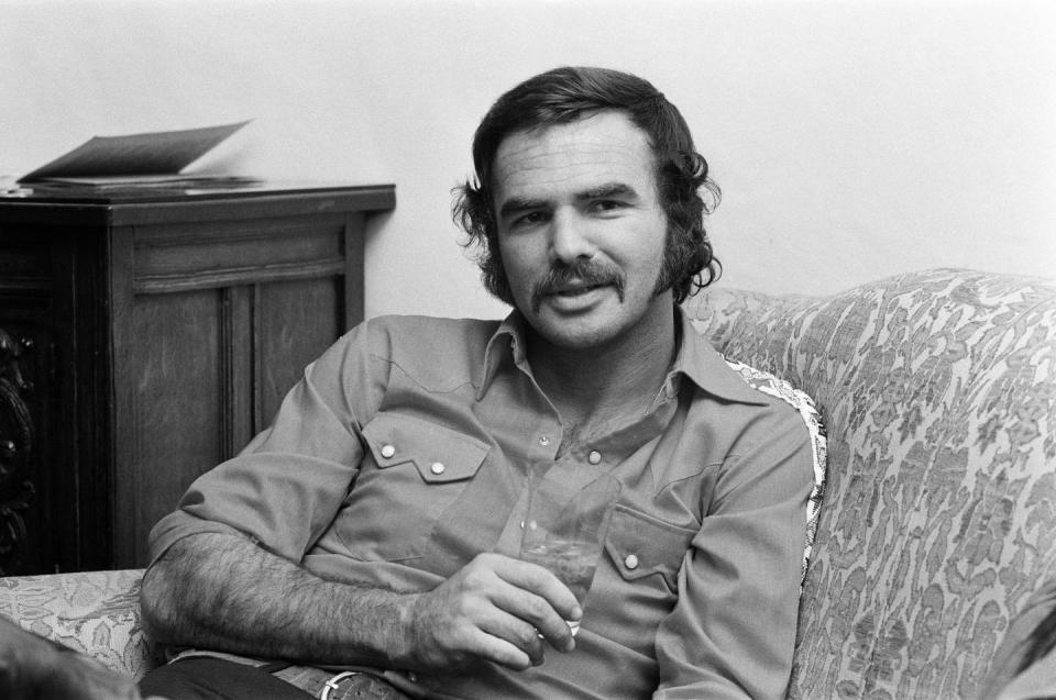 <p>Reynolds kicks back at the Dorchester Hotel in London in July 1973.</p>