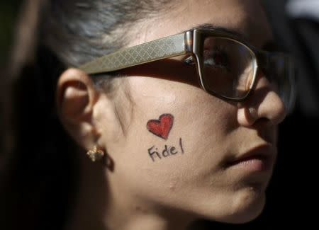 A student of Havana University participates in a tribute to Cuba's late President Fidel Castro in Havana, Cuba, November 28, 2016. The small sign reads, "Thanks for everything Commander." REUTERS/Alexandre Meneghini