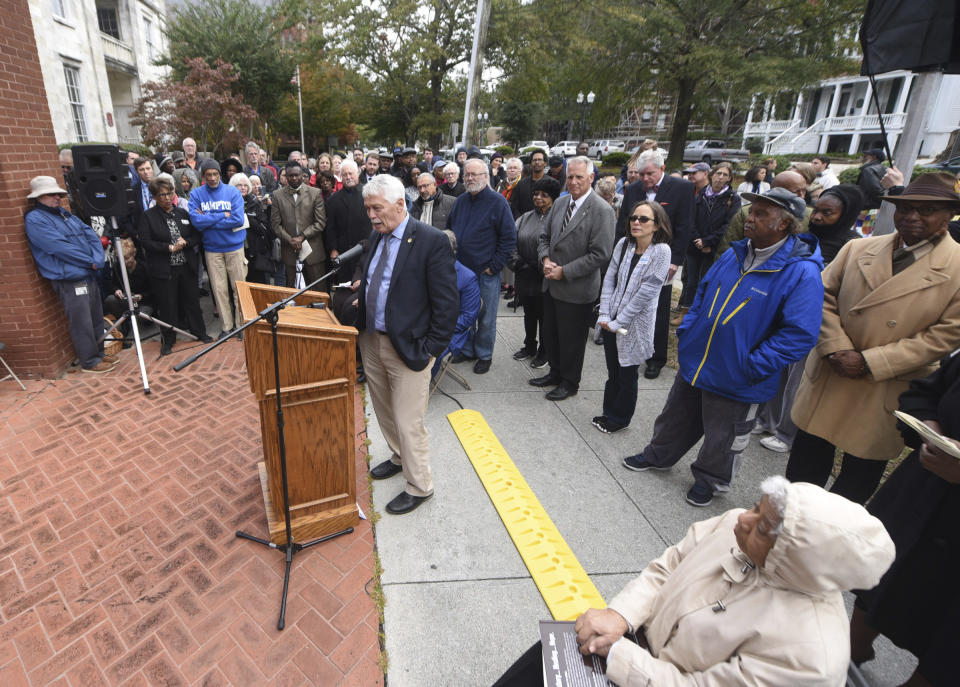 State Sen. Harper Peterson speaks during a dedication ceremony for a new North Carolina highway historical marker to the 1898 Wilmington Coup in Wilmington, N.C., Friday, Nov. 8, 2019. The marker stands outside the Wilmington Light Infantry building, the location where in 1898, white Democrats violently overthrew the fusion government of legitimately elected blacks and white Republicans in Wilmington. (Matt Born/The Star-News via AP)