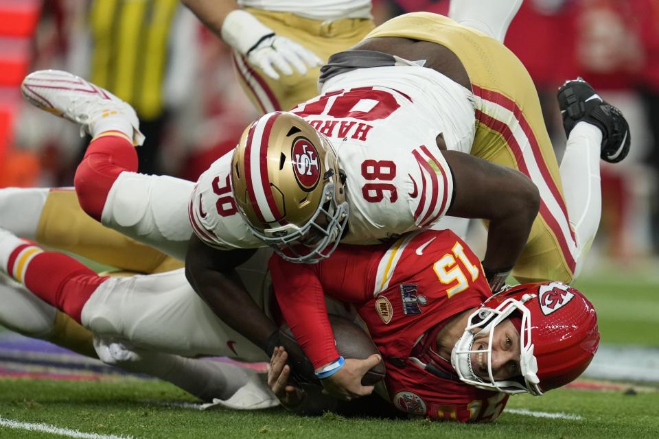 Kansas City Chiefs quarterback Patrick Mahomes (15) is hit by San Francisco 49ers defensive tackle Javon Hargrave (98) during the first half of the NFL Super Bowl 58 football game Sunday, Feb. 11, 2024, in Las Vegas. (AP Photo/Ashley Landis)