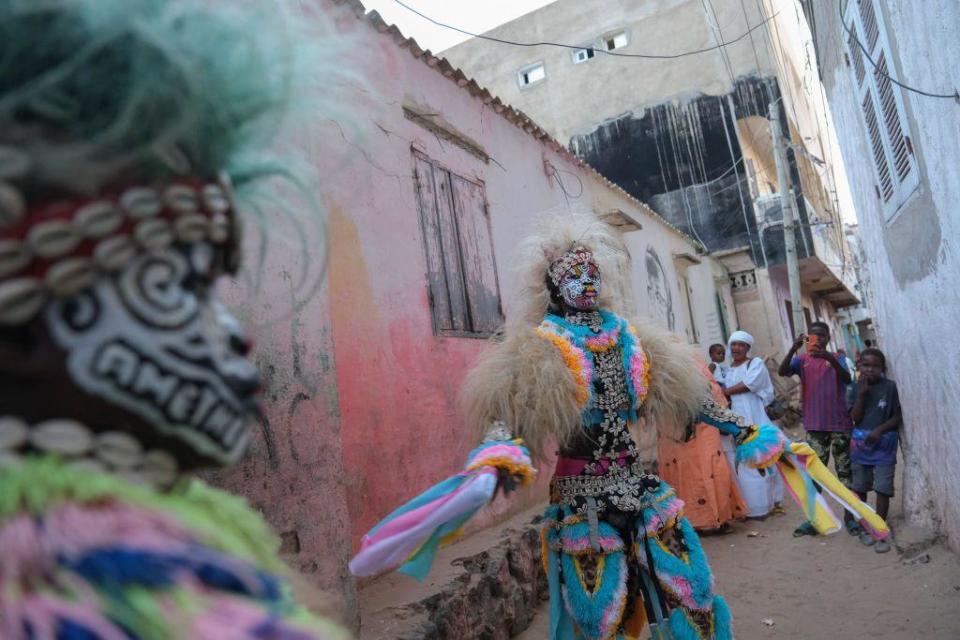 A performer dances in a traditional Simb costume during a cultural show at Ngor in Dakar, on August 12, 2024. The Simbs perform dances and rituals throughout the year in Senegal for various occasions, such as Independence Day, summer school break, wrestling matches and more. (Photo by RICCI SHRYOCK / AFP) (Photo by 