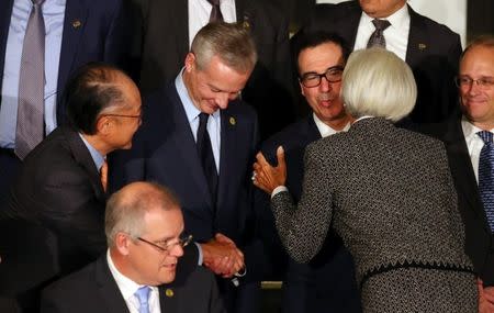 U.S. Secretary of the Treasury Steven Mnuchin kisses International Monetary Fund (IMF) Managing Director Christine Lagarde and shakes hands with World Bank president Jim Yong Kim alongside France's Finance Minister Bruno Le Maire as they arrive for the official photo at the G20 Meeting of Finance Ministers in Buenos Aires, Argentina, July 21, 2018. REUTERS/Marcos Brindicci