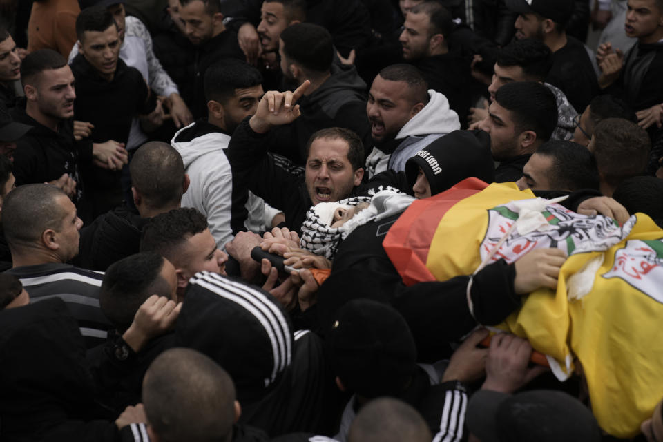 Palestinians attend the funeral of Mohammed Sherif Hassan Selmi in Qalqiliya, West Bank, Tuesday, Feb. 13, 2024. The Israeli army said that Salemi was shot and killed when he tried to overrun soldiers. (AP Photo/Majdi Mohammed)