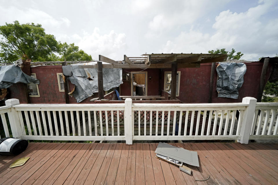A view from Lester Naquin's home that was heavily damaged by Hurricane Ida in August of 2021, shows the destroyed home of his nephew, who lived next door with his wife and child, along Bayou Pointe-au-Chien, La., Tuesday, May 24, 2022. (AP Photo/Gerald Herbert)