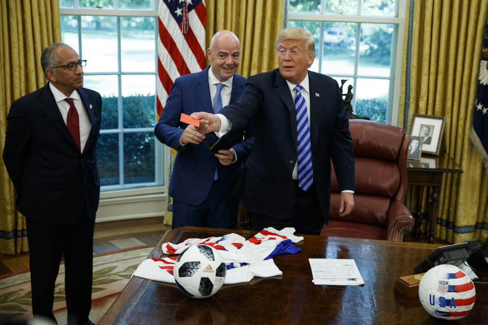 President Donald Trump handed out a red card to reporters during a meeting with the FIFA president. (AP Photo)