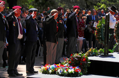 Representatives of ex-service organisations salute after laying wreaths during a memorial service at the ANZAC Memorial to mark the centenary of the Armistice ending World War One, in Sydney, Australia, November 11, 2018. REUTERS/David Gray