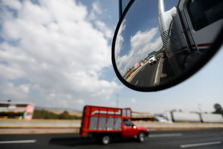 A truck is reflected in a rear-view mirror at Mexico-Puebla highway, on the outskirts of Mexico City, Mexico, March 8, 2018. Picture taken March 8, 2018. REUTERS/Edgard Garrido