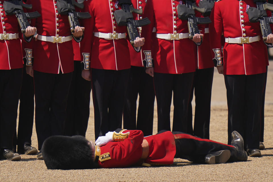 A soldier faints during the Colonel's Review, the final rehearsal of the Trooping the Colour, the King's annual birthday parade, at Horse Guards Parade in London, Saturday, June 10, 2023. (AP Photo/Alberto Pezzali)