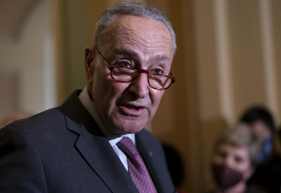 FILE - Senate Majority Leader Chuck Schumer, D-N.Y., talks to reporters about his efforts to advance their expansive social and environment bill, following a Democratic policy meeting at the Capitol in Washington, Tuesday, Dec. 14, 2021. Democrats suffered another blow to their agenda late Thursday when the Senate parliamentarian decided that hard-fought efforts to include immigration law changes should be stripped from the package because they don't comply with the chamber's rules. (AP Photo/J. Scott Applewhite, File)