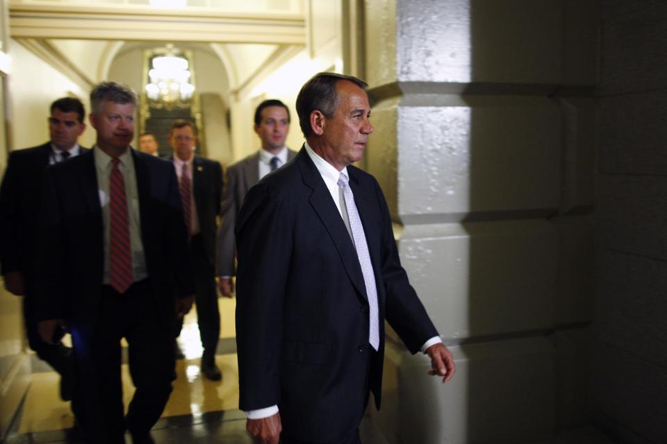 Boehner arrives for a late night closed-door meeting of the House Republican caucus during a rare Saturday session at the U.S. Capitol in Washington