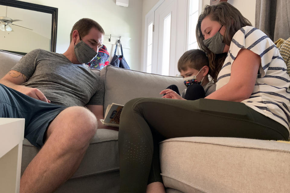 Jeff and Emily Goss read with their five-year-old son on Monday, September 13th, 2021 inside their Monroe, N.C. home. After a year of strict quarantining, the Goss' were eager for Berkeley to begin in-person learning in the Union County School District. But after board members chose not to require children to wear masks and eliminate contact tracing procedures, the Goss' decided to homeschool Berkeley. (AP Photo/Sarah Blake Morgan)