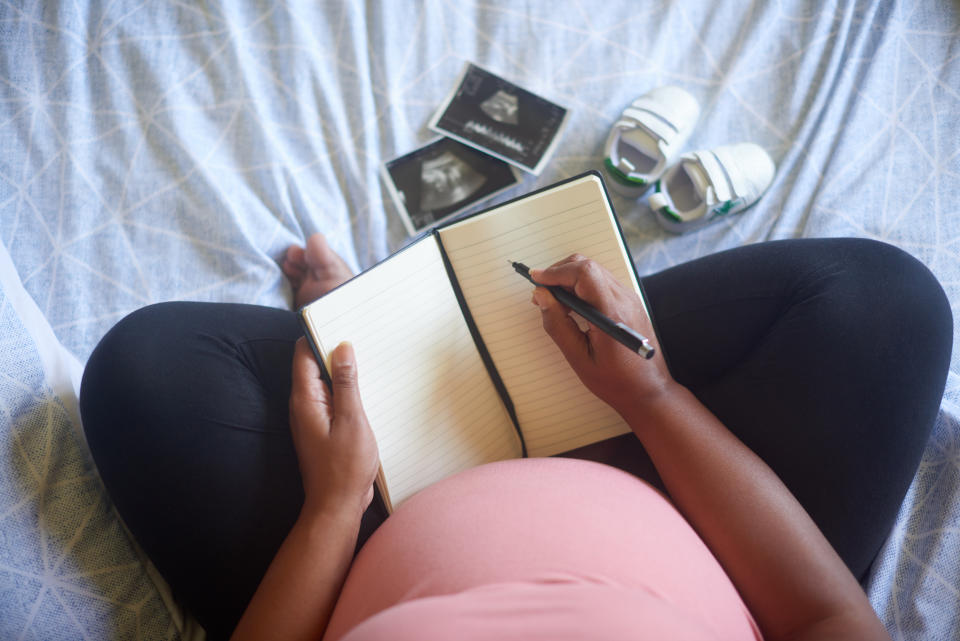 pregnant woman journaling 