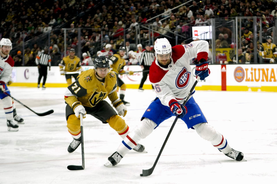 Montreal Canadiens defenseman Johnathan Kovacevic (26) skates with the puck against Vegas Golden Knights center William Karlsson (71) during the second period of an NHL hockey game, Sunday, March 5, 2023, in Las Vegas. (AP Photo/Lucas Peltier)