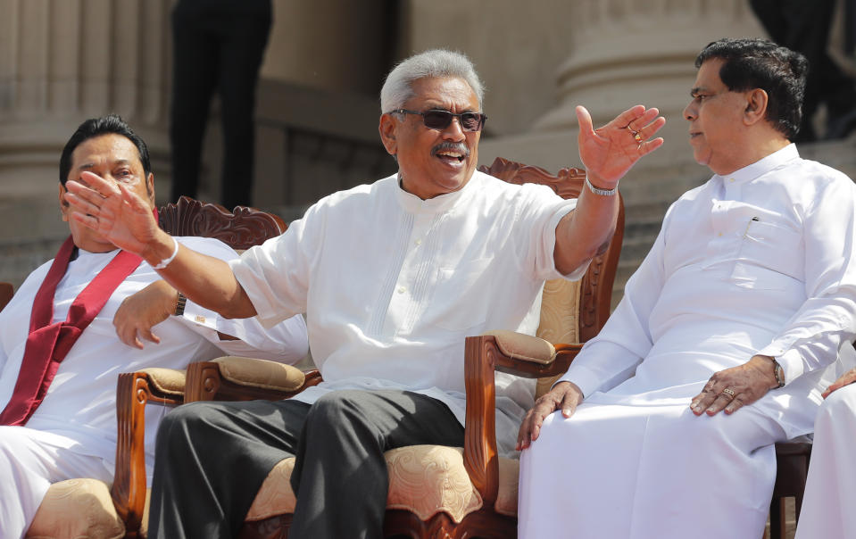 Sri Lankan president Gotabaya Rajapaksa, center, speaks with his cabinet colleagues in Colombo, Sri Lanka, Friday, Nov. 22, 2019. Rajapaksa, who was elected last week, said he would call a parliamentary election as early as allowed. The parliamentary term ends next August, and the constitution allows the president to dissolve Parliament in March and go for an election. (AP Photo/Eranga Jayawardena)