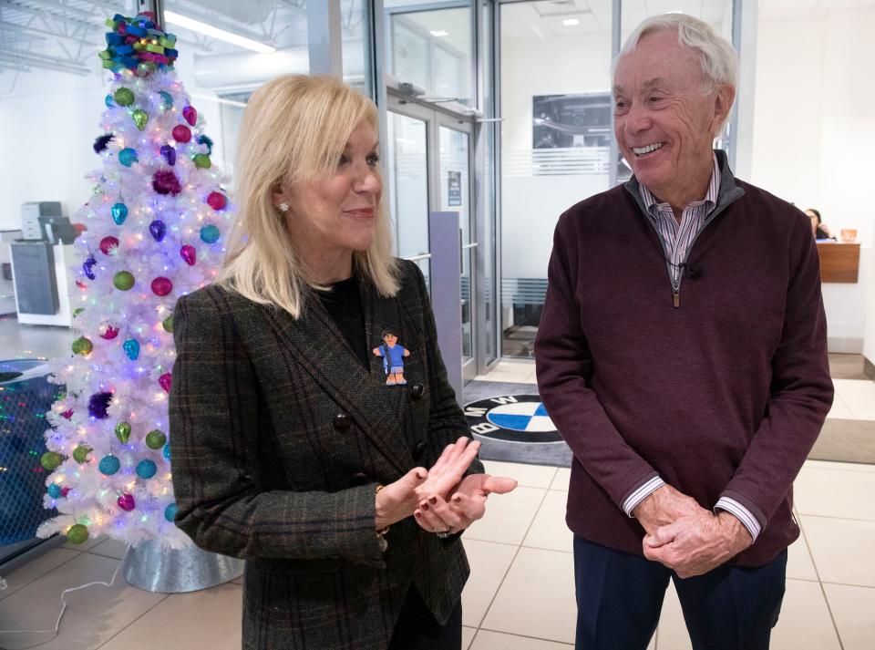 Teri Levin offers words of praise for Sandy Sansing for his support of the Gulf Coast Kid's House during a brief ceremony at his BMW dealership on Tuesday.