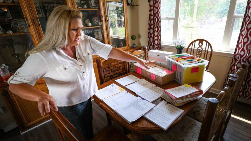 Piles of paperwork about Ashlynn Miles’ medical history cover the table at the Paso Robles home of her mother, Kimberlee Booth. Booth is not allowed to have her daughter at home for the protection of other children in the household.