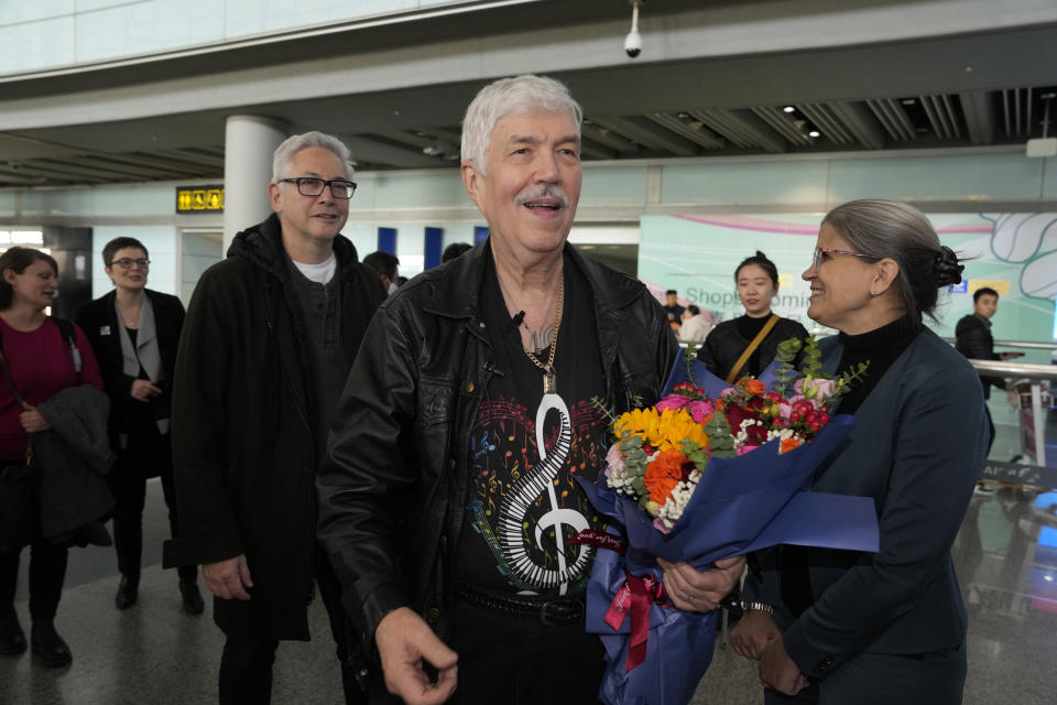 Philadelphia Orchestra's 73-year-old violinist Davyd Booth, center, leads other members as they arrive at the Beijing Capital International Airport on Tuesday, Nov. 7, 2023. Musicians from the Philadelphia Orchestra arrived in Beijing on Tuesday, launching a tour commemorating its historic performance in China half a century ago in signs of improving bilateral ties ahead of a highly anticipated meeting between President Joe Biden and Xi Jinping. (AP Photo/Ng Han Guan)