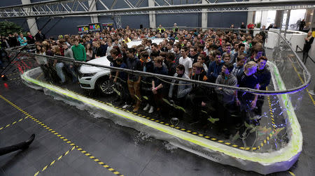 275 participants and a car stand inside a soap bubble to achieve the Guinness World Record for the most people surrounded by a soap bubble in Mlada Boleslav, Czech Republic, January 18, 2017. REUTERS/David W Cerny