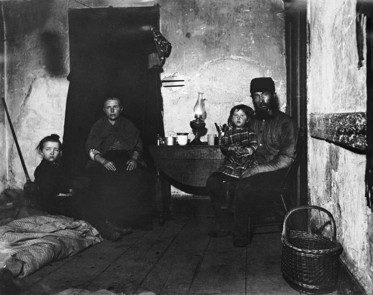 A poverty-stricken family living in New York’s Lower East Side, circa 1890.