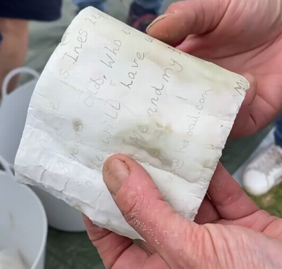 A handwritten note on the tattered paper.