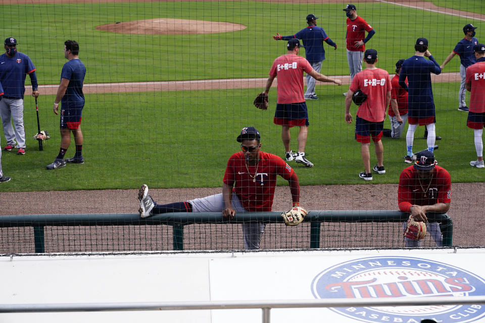 Minnesota Twins shortstop Jorge Polanco (11) stretches near the dugout during spring training baseball practice on Wednesday, Feb. 24, 2021, in Fort Myers, Fla. (AP Photo/Brynn Anderson)