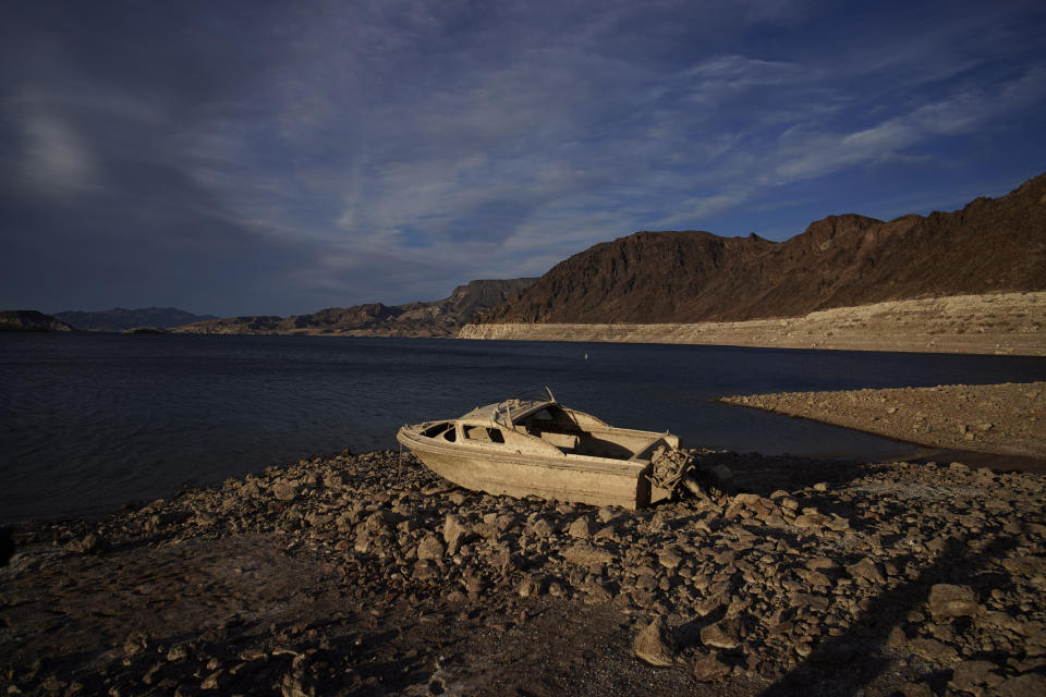 FILE - A formerly sunken boat sits high and dry along the shoreline of Lake Mead at the Lake Mead National Recreation Area, Tuesday, May 10, 2022, near Boulder City, Nev. The Biden administration on Tuesday, April 11, 2023 released an environmental analysis of competing plans for how Western states and tribes reliant on the dwindling Colorado River should cut their use. (AP Photo/John Locher,File)