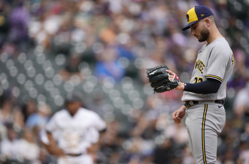 Milwaukee Brewers relief pitcher Peter Strzelecki waits to be pulled from the mound after giving up a walk to Colorado Rockies' Brenton Doyle in the eighth inning of a baseball game Thursday, May 4, 2023, in Denver. (AP Photo/David Zalubowski)