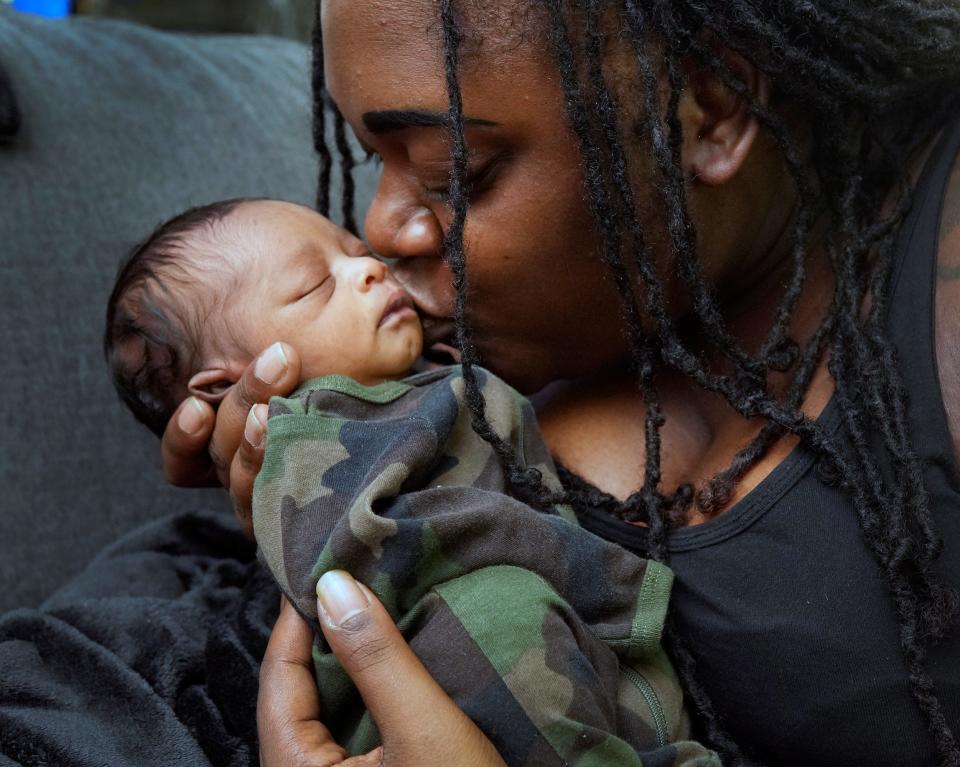 Isis Davis with her newborn son, Akovi, at their Palm Coast home, Monday, July 2, 2023.