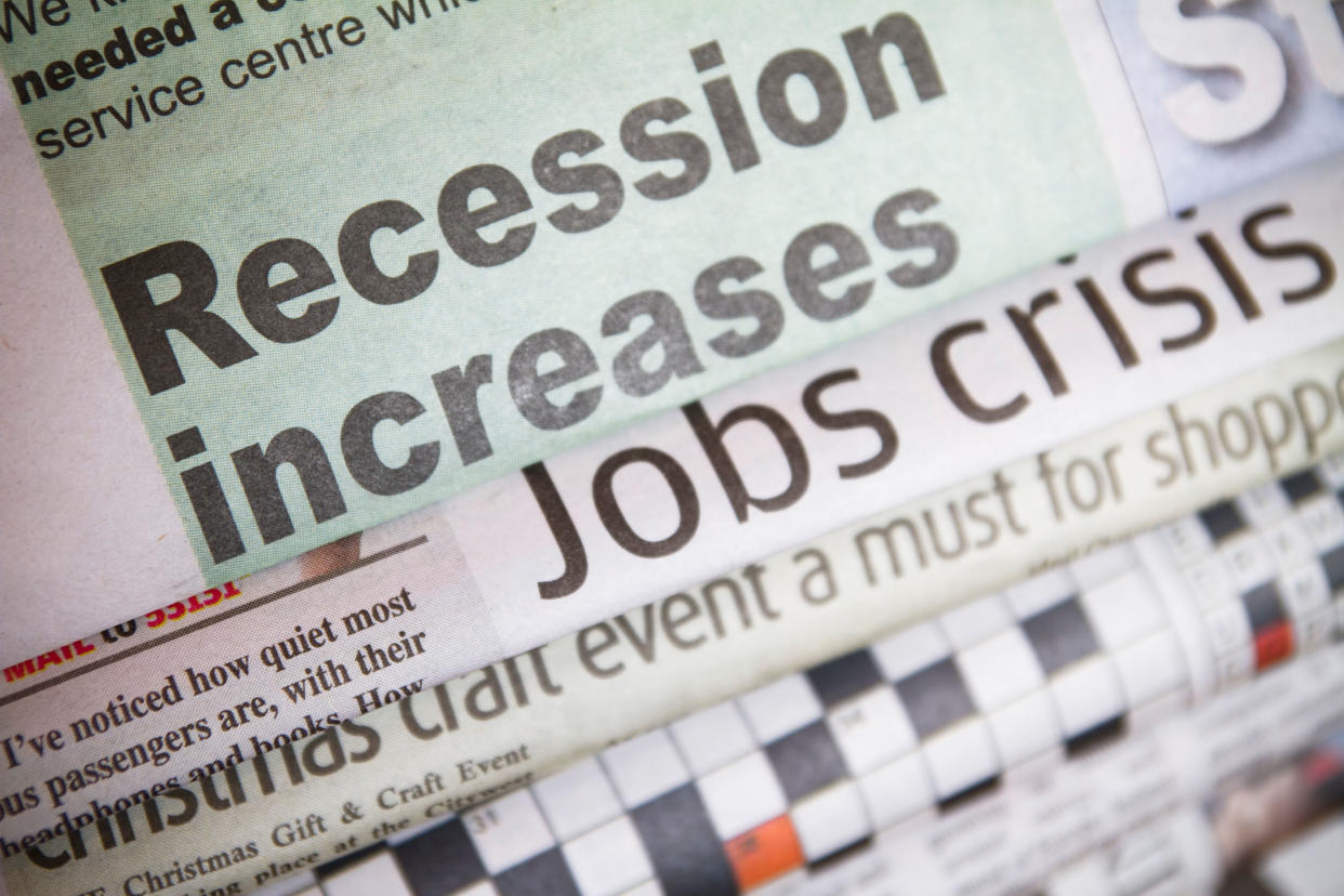 A pile of newspapers taking about a recession and job cuts