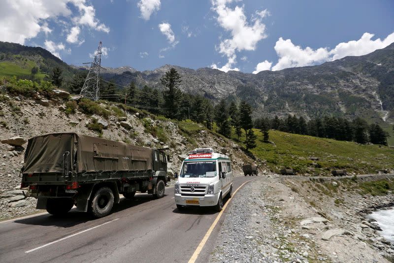 FILE PHOTO: Ambulance moves past Indian Army convoy along a highway leading to Ladakh, at Gagangeer